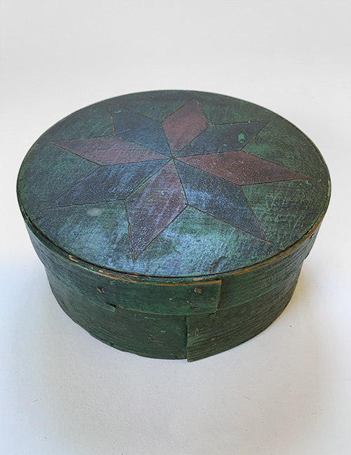 antique painted wooden pantry box with sailor made 8 pointed star in red black and green original surface