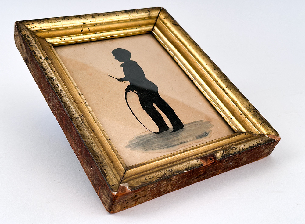antique folk art hollow cut silhouette boy with hoop toy