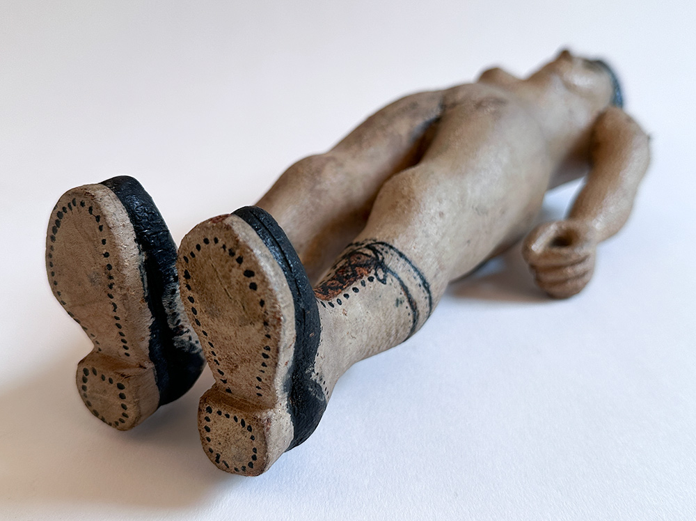 paint decorated wooden folk art carving of nude woman in boots