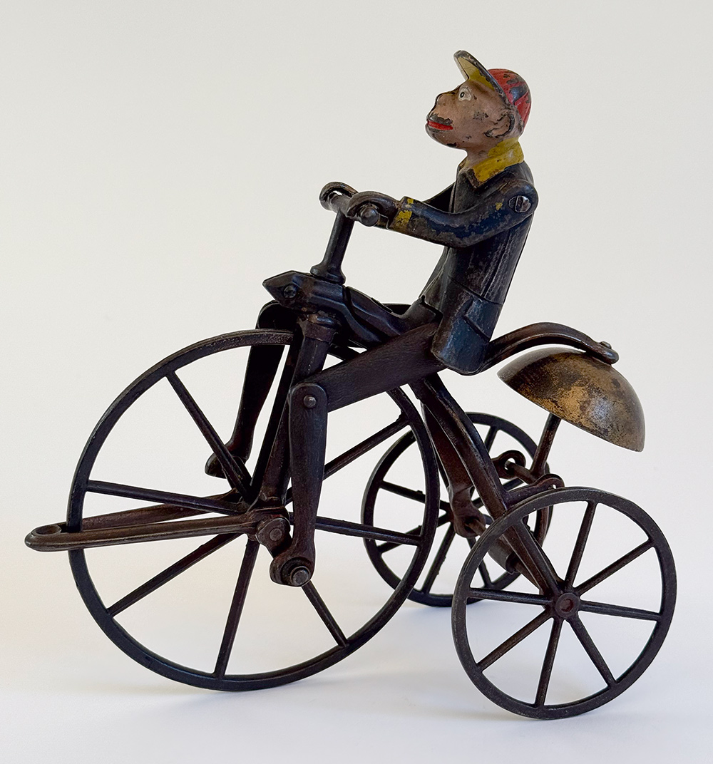 original j and e stevens cast iron deluxe painted and japanned monkey on tricycle bell toy