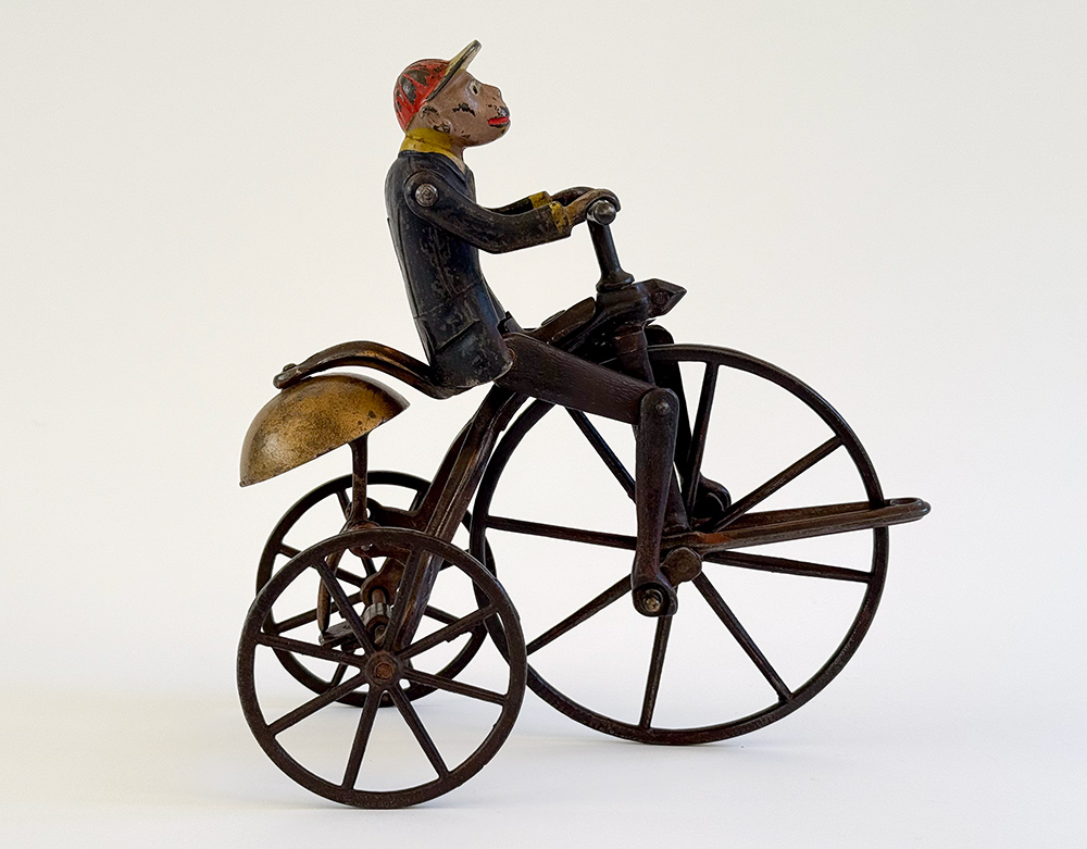 original j and e stevens cast iron deluxe painted and japanned monkey on tricycle bell toy