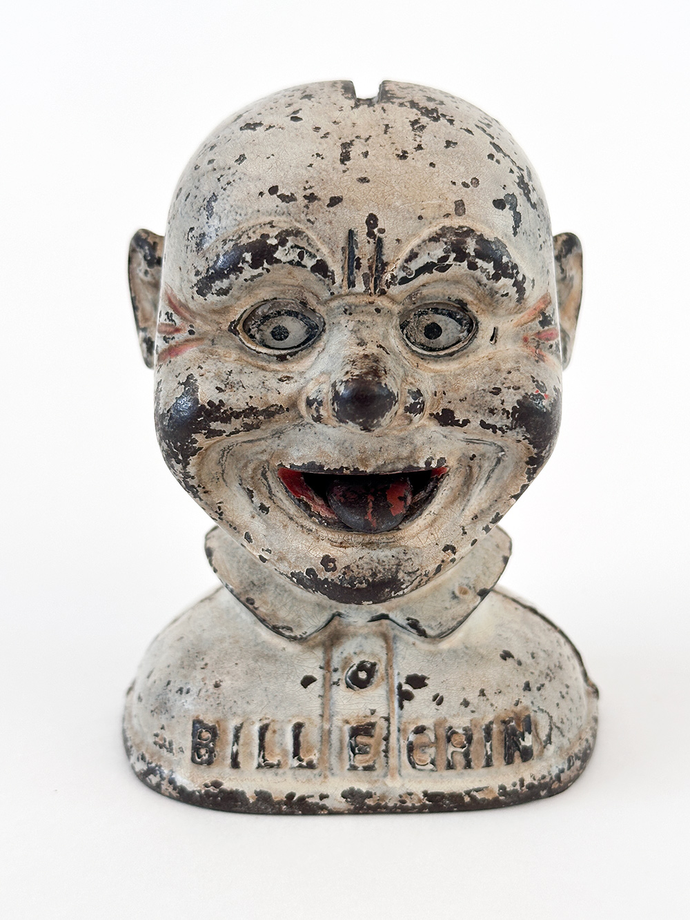 original cast iron j and e stevens bill e grin mechanical bank with red base