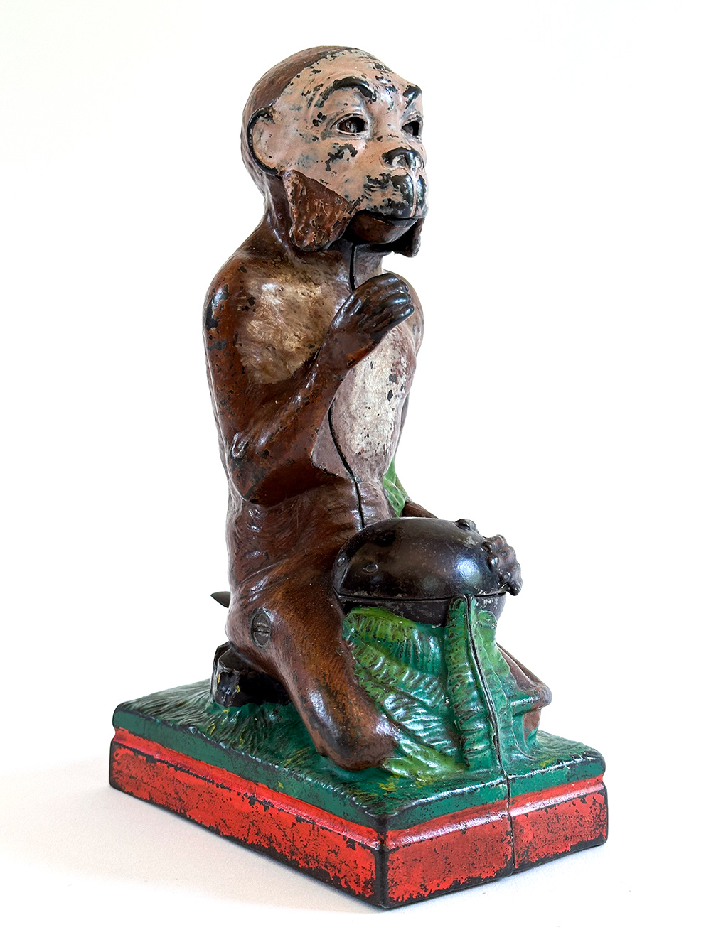 original cast iron monkey and coconut mechanical bank with red base