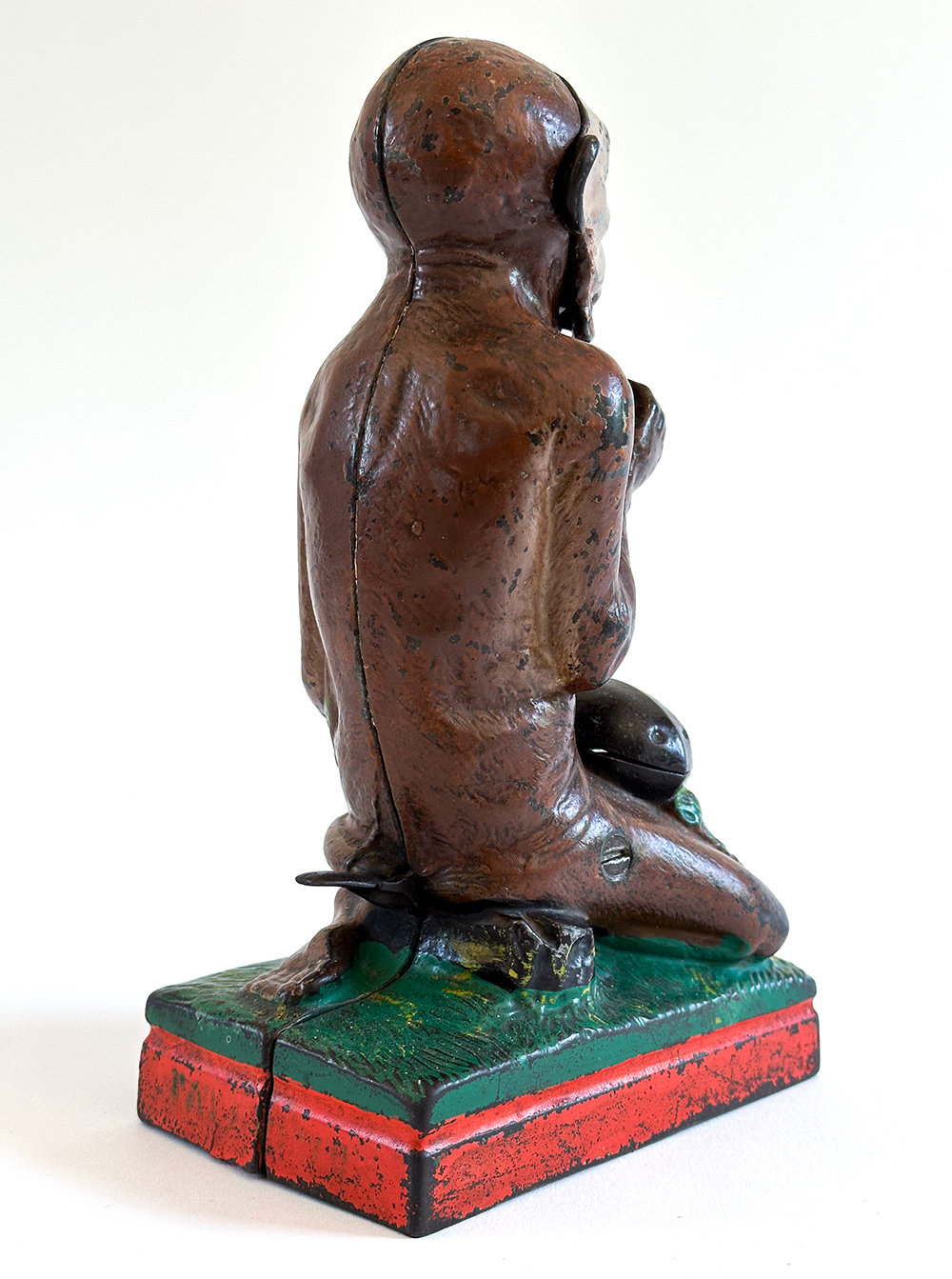 original cast iron monkey and coconut mechanical bank with red base