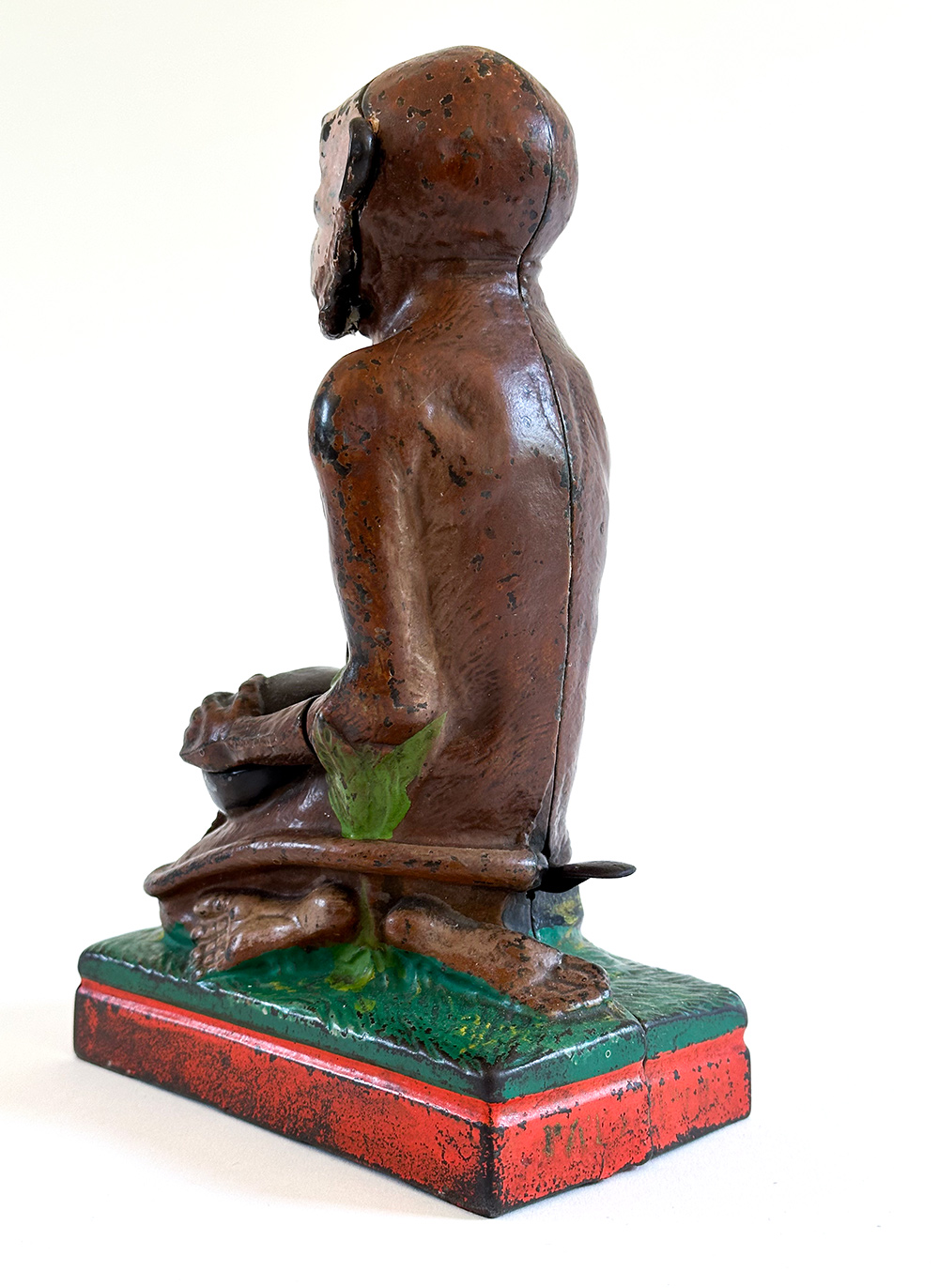 original cast iron monkey and coconut mechanical bank with red base