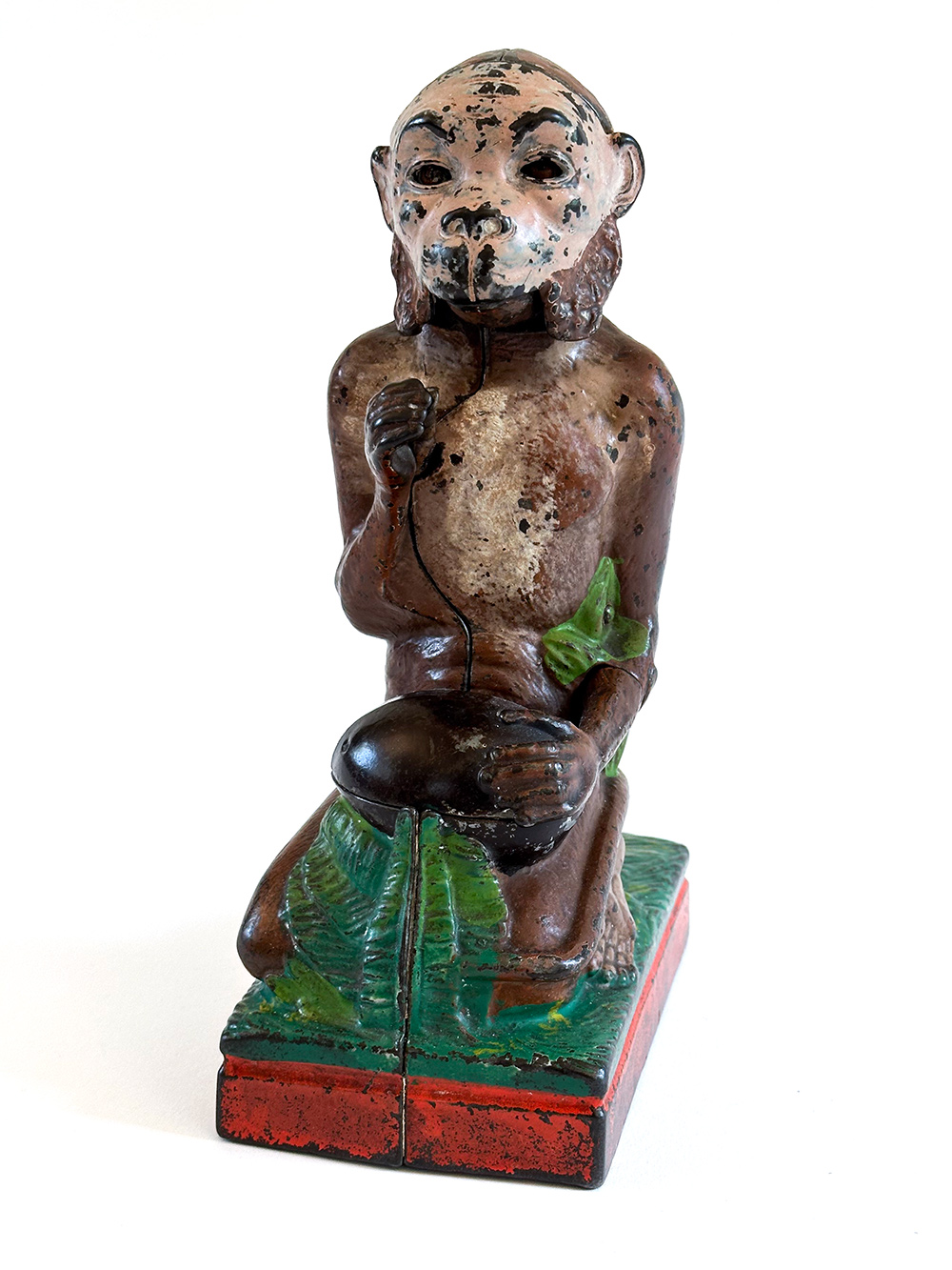 original cast iron monkey and coconut mechanical bank with red base