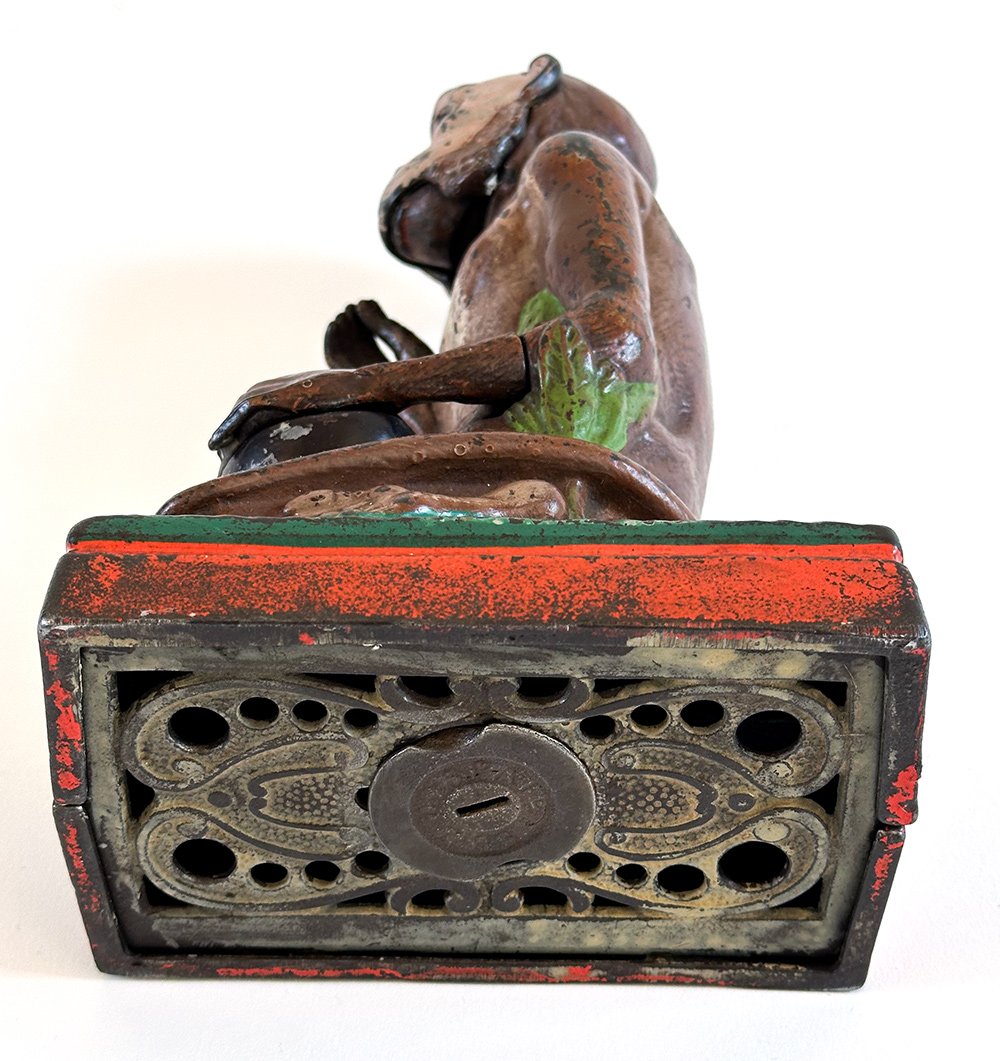 original cast iron monkey and coconut mechanical bank with red base