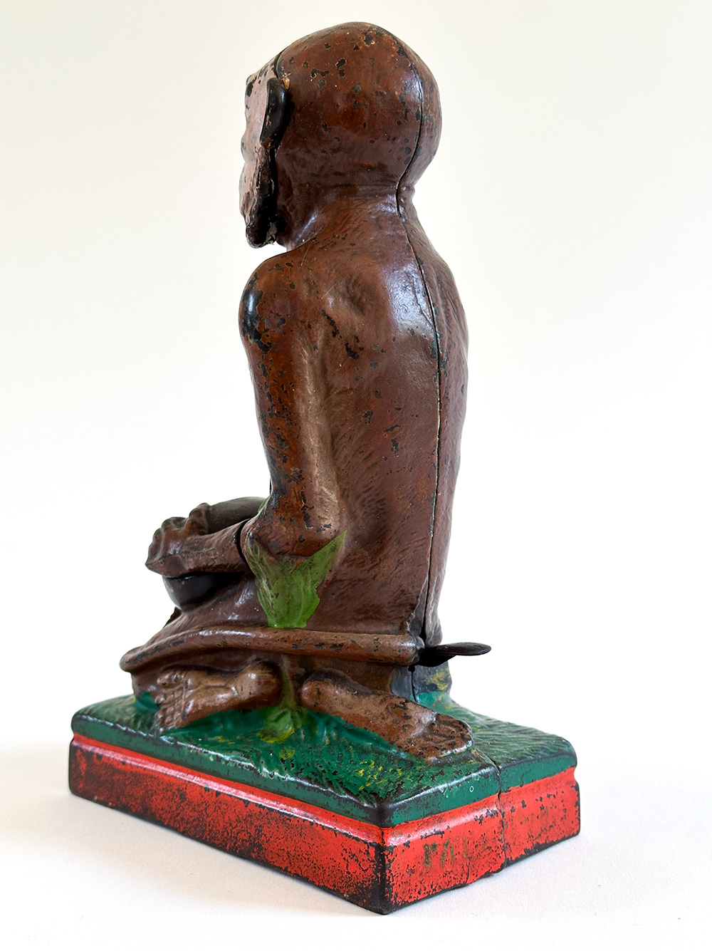 original cast iron monkey and coconut mechanical bank with red base